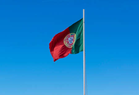 Portuguese flag waving against skyの写真素材