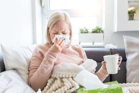 Cold And Flu. Portrait Of Ill Woman Caught Cold, Feeling Sick And Sneezing In Paper Wipe. Unhealthy...