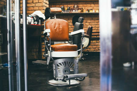 Stylish Vintage Barber Chair In brick wall Interior. Barbershop Theme. Barbershop armchair. Modern hairdresser and hair salon, barber shop for menの素材 [FY310188701257]