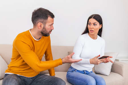 Infidelity. Jealous boyfriend Showing his Cheating girlfriend her Phone Demanding Explanation...
