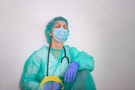 Tierd Doctor, nurse in PPE suit uniform has stress in Coronavirus outbreak or Covid-19, Concept of...