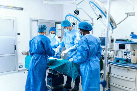 Group of medical team urgently doing surgical operation and helping patient in theater at hospital....