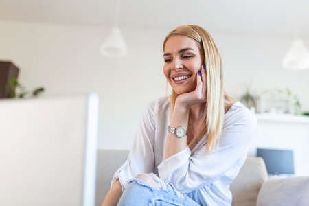 Beautiful woman freelancer noting information for planning project doing remote job via laptop...