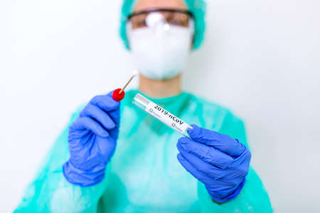 virus respiratory sputum specimen swab test tube with gloves, mask and biohazard bag.