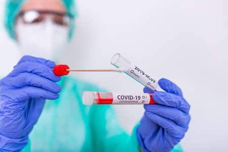 Nasal swab laboratory test in hospital lab, Nurse holding test tube with blood
