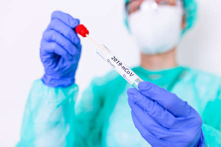 Diagnostic testing . Nasal swab laboratory test in hospital lab. Specialist holding test tube with cotton swab.の写真素材