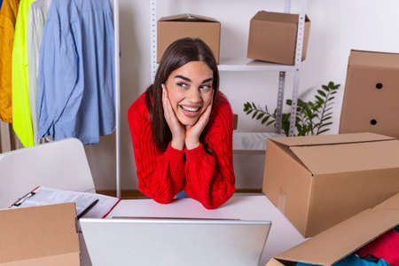 Young woman owner of online business. Successful and happy young woman entrepreneur selling online...
