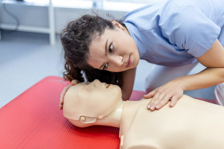 woman practicing cpr technique on dummy during first aid training. First Aid Training - Cardiopulmonary resuscitation. First aid course on cpr dummy.の写真素材