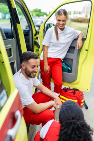 Paramedics at work with an ambulance. Paramedic nurse and emergency doctor at ambulance with kit