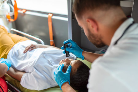 Close-up Portrait Shot of a Serious and Focused Paramedic in an Ambulance Vehicle with an Injured...