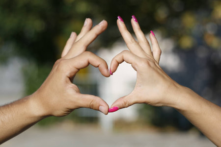 winged heart by hands between boy and girlの写真素材