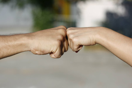 knuckles touch, girl fist to boy fist, female to male fist touchの写真素材