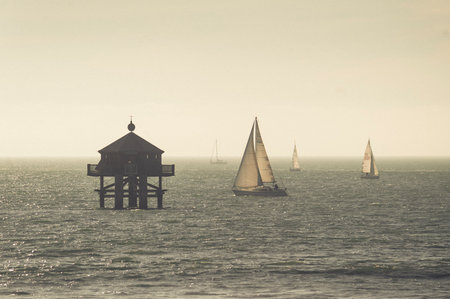 Sailboats in a warm light on the Atlantic seaの写真素材