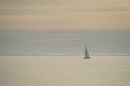 Sailboat on the atlantic ocean in a warm lightの写真素材