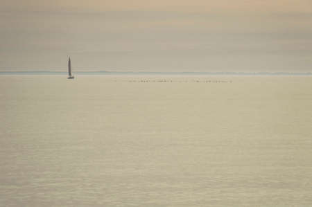 Sailboats in a warm light on the Atlantic seaの写真素材