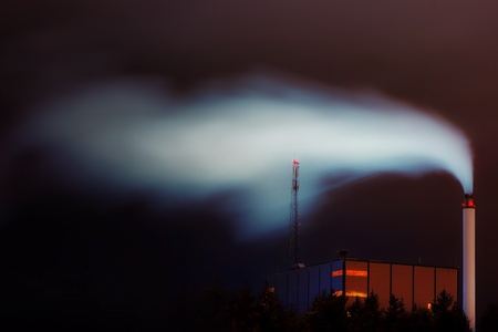 Power plant in the night with wite bright smokeの写真素材