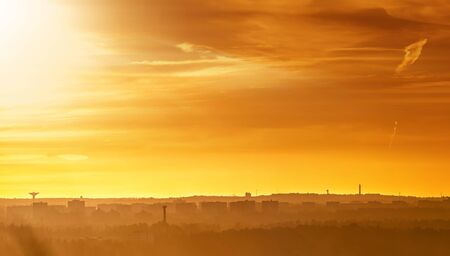 Orange sunset over a cityscape showing silhouette skyline of southern Stockholm, Swedenの写真素材