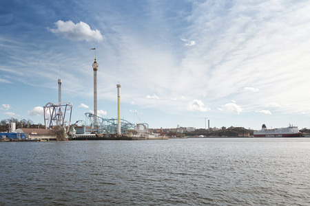 STOCKHOLM - APRIL 12: The amusement park Grona Lund from the seaside with a Viking cruise ship in the background. April 12, 2014 in Stockholm, Sweden. Grona Lund was founded in 1883.のeditorial素材
