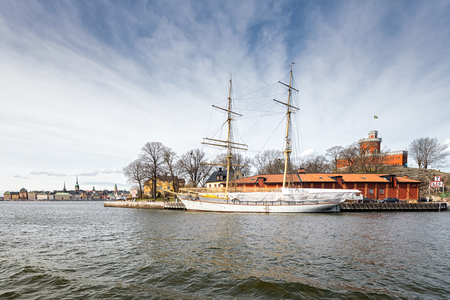 STOCKHOLM - APRIL 12: The brig Tre kronor af Stockholm at Skeppsholmen with the Old town in background. April 12, 2014 in Stockholm, Sweden. In the season of 2008 she made her maiden journey.のeditorial素材