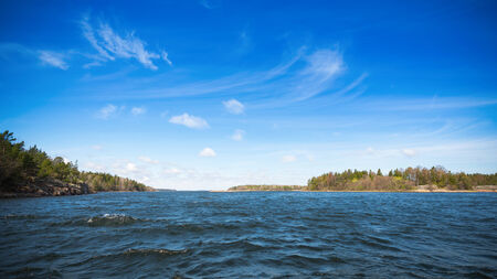 Sea view with blue sky and small waves or ripples in a scandinavian landscape, Swedenの写真素材