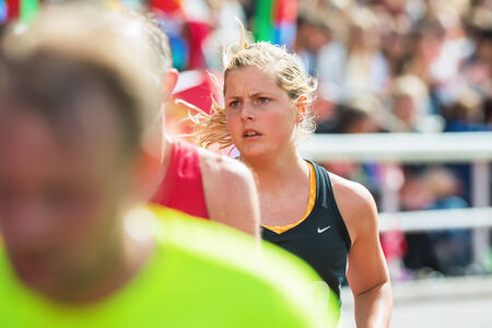 STOCKHOLM - MAY 31: Closeup of a young womans face at the final stretch at Stockholm Stadion in ASICS Stockholm Marathon 2014. May 31, 2014 in Stockholm, Sweden.のeditorial素材