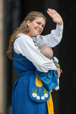 STOCKHOLM - JUNE 6: Princess Madeleine of Sweden with Princess Leonore waving to the public after the cermony of opening the palace to the public. March 18, 2014 in Stockholm, Sweden.のeditorial素材