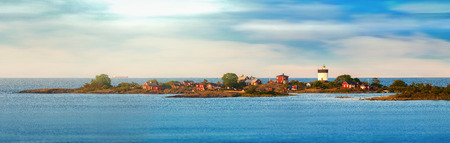 Beautiful panoramic nightly seascape with lighthouse and moody sky at the sunset, Grisslehamn, - Swedenの写真素材