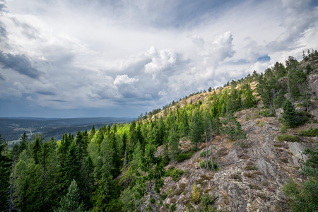 Sunlight at a mountainside during bad weather. High coast, Sweden