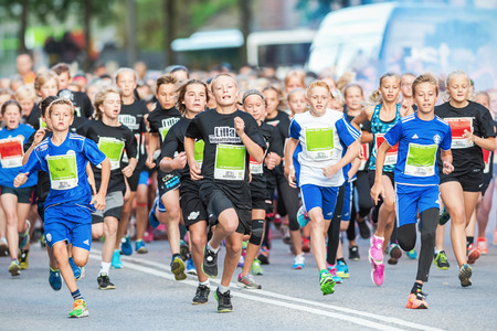 STOCKHOLM - AUG, 16: The leading group just after the start in the Midnight Run for children (Lilla Midnattsloppet) event. Aug 16, 2014 in Stockholm, Swedenのeditorial素材