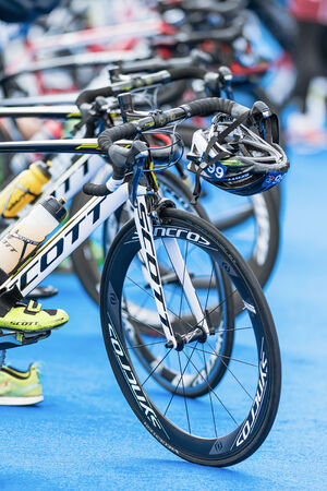 STOCKHOLM - AUG, 23: Front wheels of triathlon bikes with all other equipment at the transition zone in the Mens ITU World Triathlon Series event Aug 23, 2014 in Stockholm, Swedenのeditorial素材