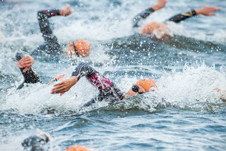 STOCKHOLM - AUG, 23: Triathletes swimming in the cold water at the Womans ITU World Triathlon Series event August 23, 2014 in Stockholm, Swedenのeditorial素材