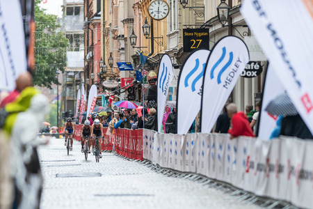 STOCKHOLM - AUG, 23: Group of women triahtletes cycling in the rain in the old town at the Womans ITU World Triathlon Series event August 23, 2014 in Stockholm, Swedenのeditorial素材