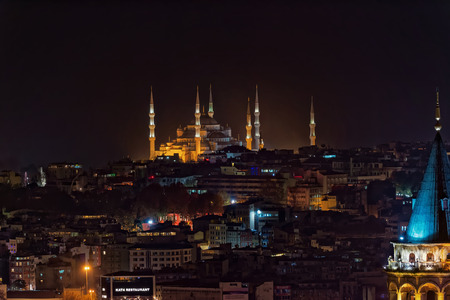ISTANBUL, NOV 13: Blue mosque during night from the Marmara district with the Galata tower in the foreground. November 2013 in Istanbul, Turkeyのeditorial素材