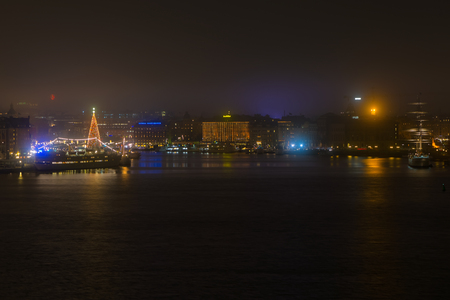 STOCKHOLM, DEC 31: View over Stockholm during New Years evening with Grand Hotel and af Chapman, Stockholm, Sweden in December 31, 2014. Foggy night.のeditorial素材
