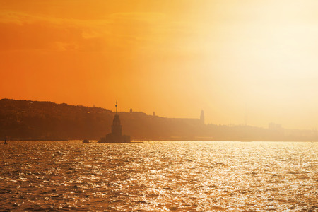 Maidens Tower in warm yellow morning light in Istanbul City, Turkeyの写真素材