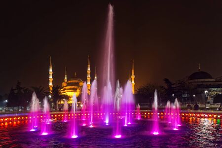 ISTANBUL, TURKEY - NOV 19: Istanbul by night with colorful fountain with the blue mosque in the background, Istanbul, November 19, 2013 in Istanbul, Turkey.のeditorial素材