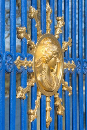 STOCKHOLM, SWEDEN - APRIL 13: Entrance emblem in gold and fence in blue to the royal park Djurgarden, April 13, 2015 in Stockholm, Sweden.のeditorial素材