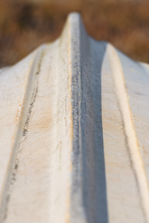 Small boat upside down, used white keel with scratches, detailed short depth of fieldの写真素材