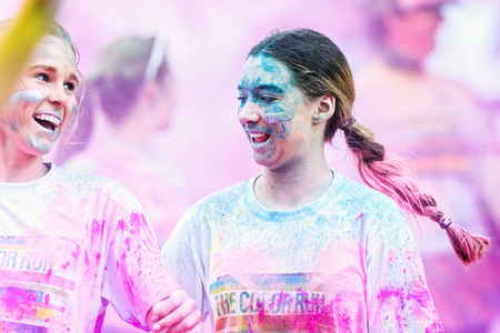 STOCKHOLM, SWEDEN - MAY 23: Two happy colorful girls in purple at Stockholm Color Run in Tantolunden or Tanto on May 23, 2015. People from all walks of life participated in the run.のeditorial素材
