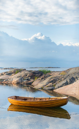 Vintage rowingboat moored in warm evening light. Swedenの写真素材