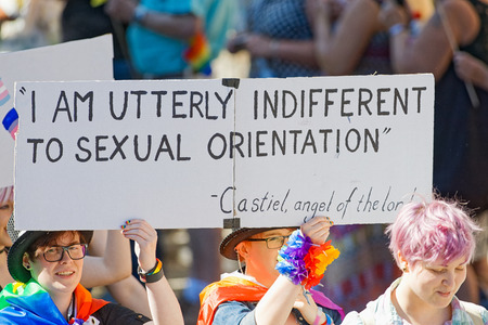 STOCKHOLM, SWEDEN - AUGUST 1, 2015: Young women holding a sign with text at the Pride parade in...