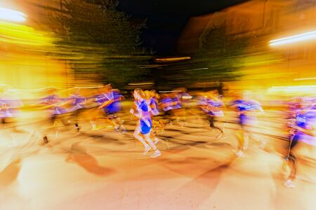 STOCKHOLM, SWEDEN - AUGUST 15, 2015: Runners in motion blur and colorful light trails on the streets at Midnattsloppet or the Midnight run. The track is 10 km and goes thru the streets of Stockholm.のeditorial素材