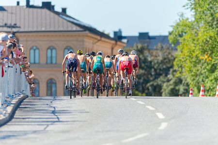 STOCKHOLM - AUG 22, 2015: Leading group of triathlete cyclists in the Womens ITU World Triathlon series event.のeditorial素材