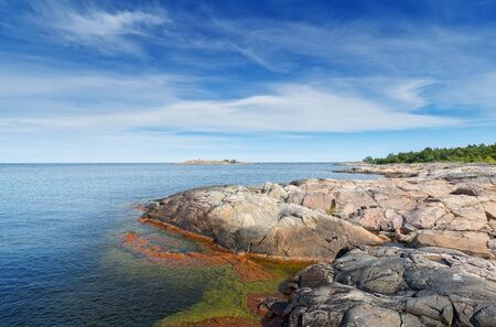 Rocky coastline in vivid colors during a beautiful summer day. Grisslehamn, Swedenのeditorial素材