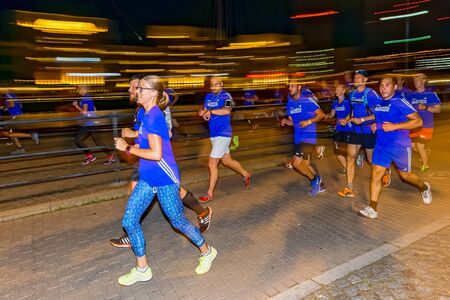 STOCKHOLM, SWEDEN - AUGUST 15, 2015: Group of runners with motion blur on the streets of Soder at Midnattsloppet or the Midnight run. The track is 10 km and goes thru the streets of Stockholm.のeditorial素材