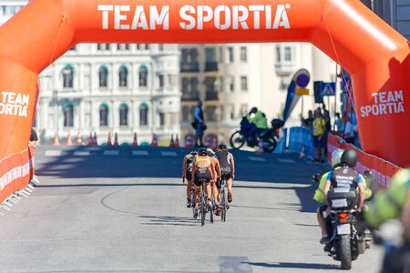 STOCKHOLM - AUG 22, 2015: Group of triathletes cycling past the royal castle at the Womens ITU World Triathlon series event in Stockholm.のeditorial素材