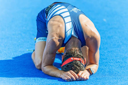 STOCKHOLM - AUG 23, 2015: Exhausted triathlete at the finish area at the ITU World Triathlon event in Stockholm.のeditorial素材