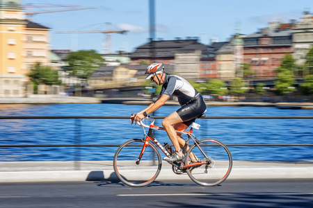 STOCKHOLM - AUG 23, 2015: Triathlete with a older rider in the cycling part with motion blur of the panning at the ITU World Triathlon event in Stockholm.のeditorial素材