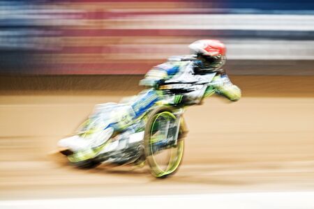 STOCKHOLM - SEPT 25, 2015: Speedway rider in motionblur at the TEGERA Stockholm FIM Speedway Grand Prix at Friends Arena in Stockholm.のeditorial素材