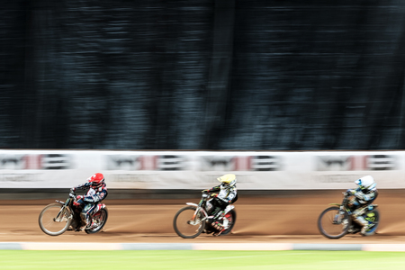 STOCKHOLM - SEPT 26, 2015: Three speedway racers in action with motion blur at the TEGERA Stockholm FIM Speedway Grand Prix at Friends Arena in Stockholm.のeditorial素材